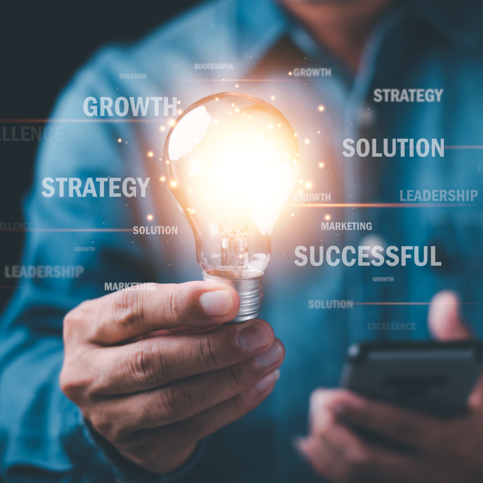 Businessman holding light bulb showing business strategy concept,development concept, business efficiency and growth, financial and economic success goals,Industry Leadership and business competitors